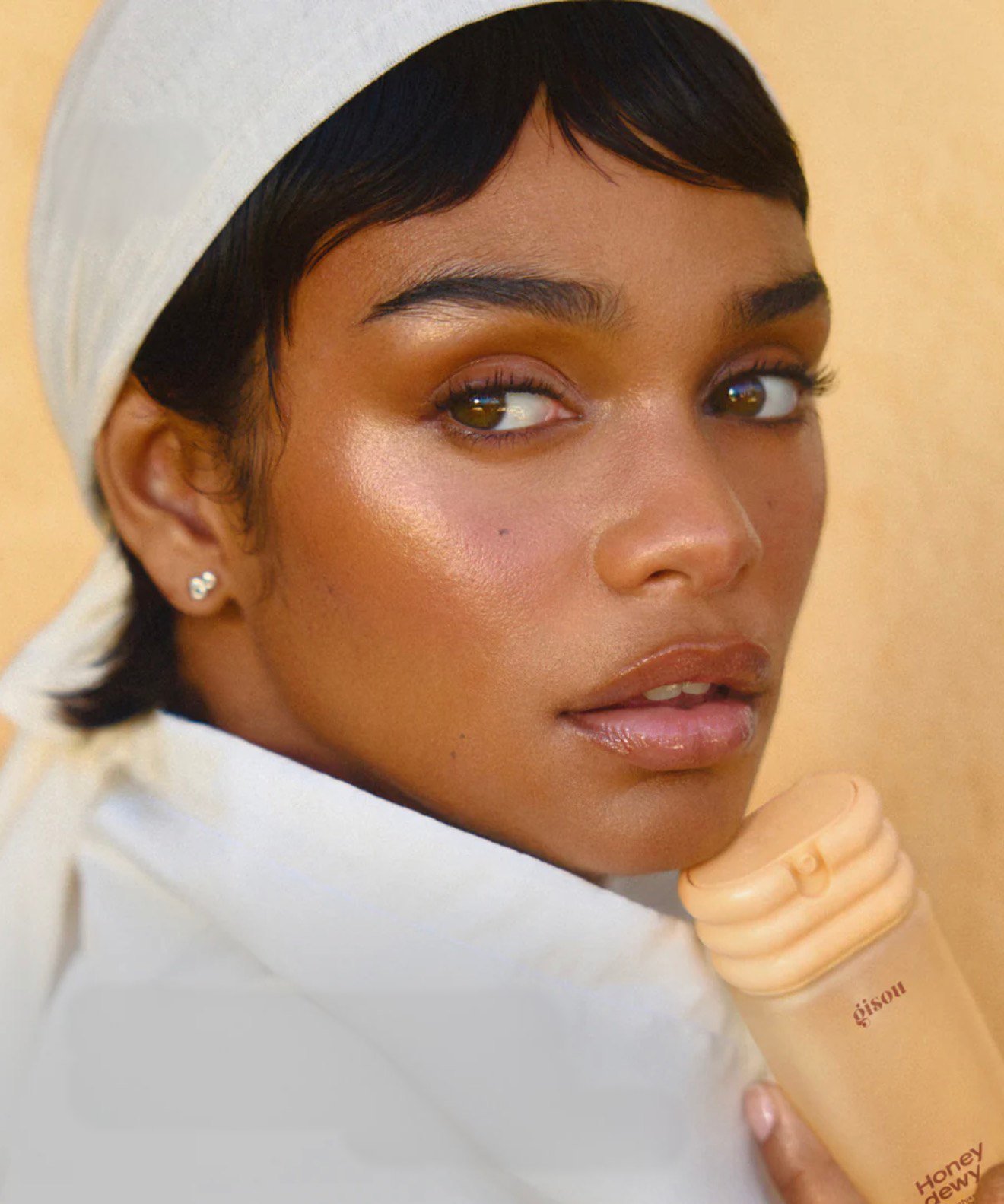 Gisou campaign: model in a cream headscarf with a short glossy fringe