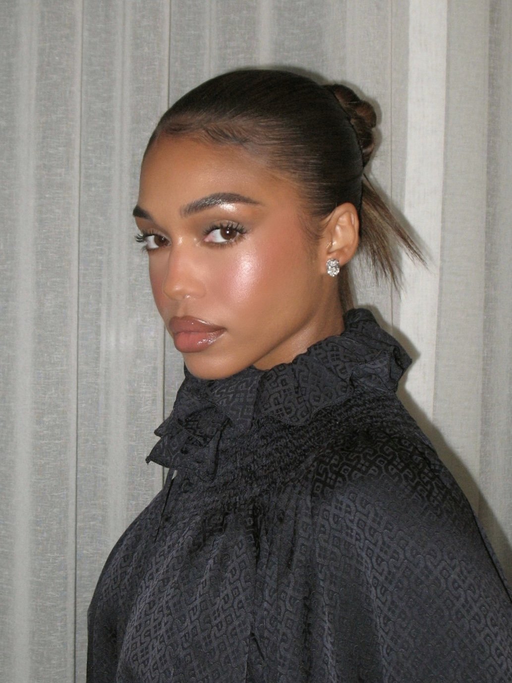 Lori Harvey with a sleek, high-shine bun